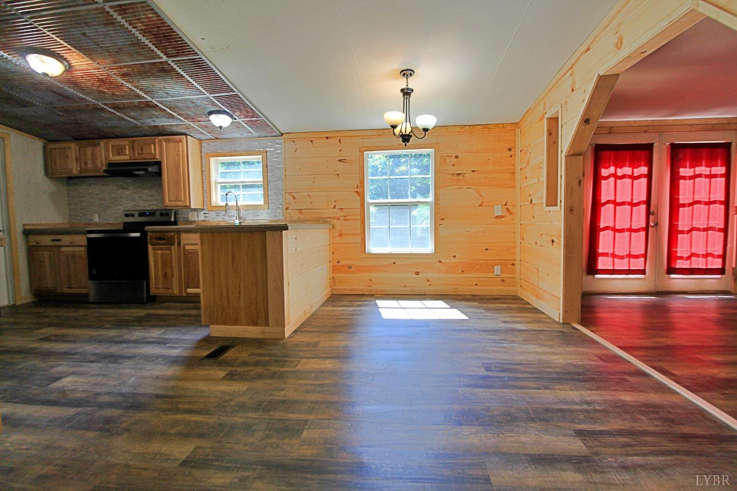 182 Shelton Store Road Wingina, VA 24599 - Photo 15 of 30 a view of a kitchen with a stove cabinets and wooden floor