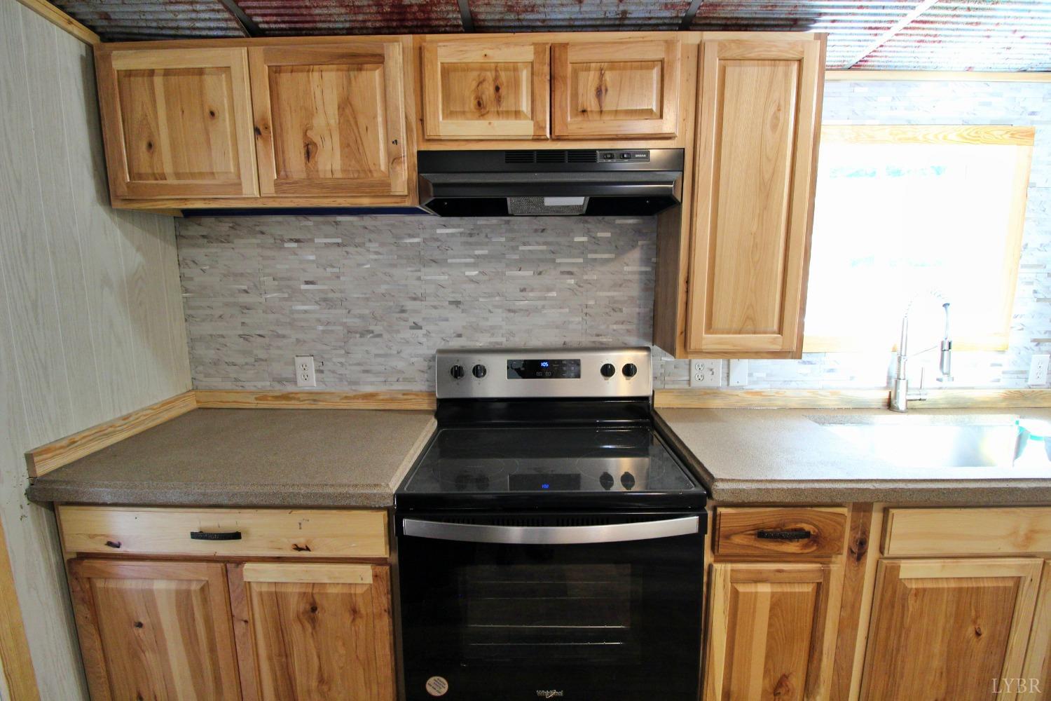 182 Shelton Store Road Wingina, VA 24599 - Photo 10 of 30 a kitchen with granite countertop a stove top oven