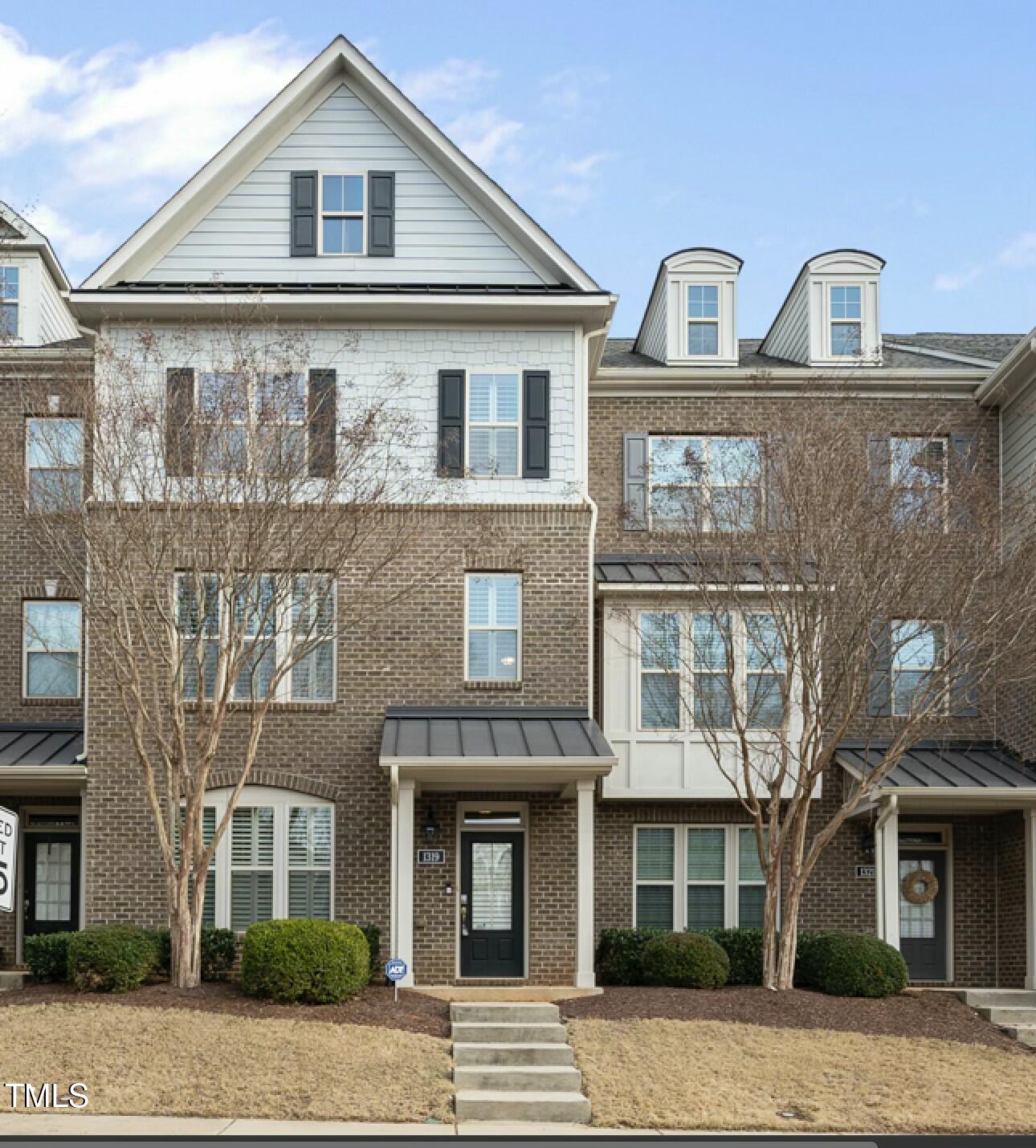 1319 Rodessa Run Raleigh, NC 27607 - Photo 1 of 34 a front view of a house with yard and parking