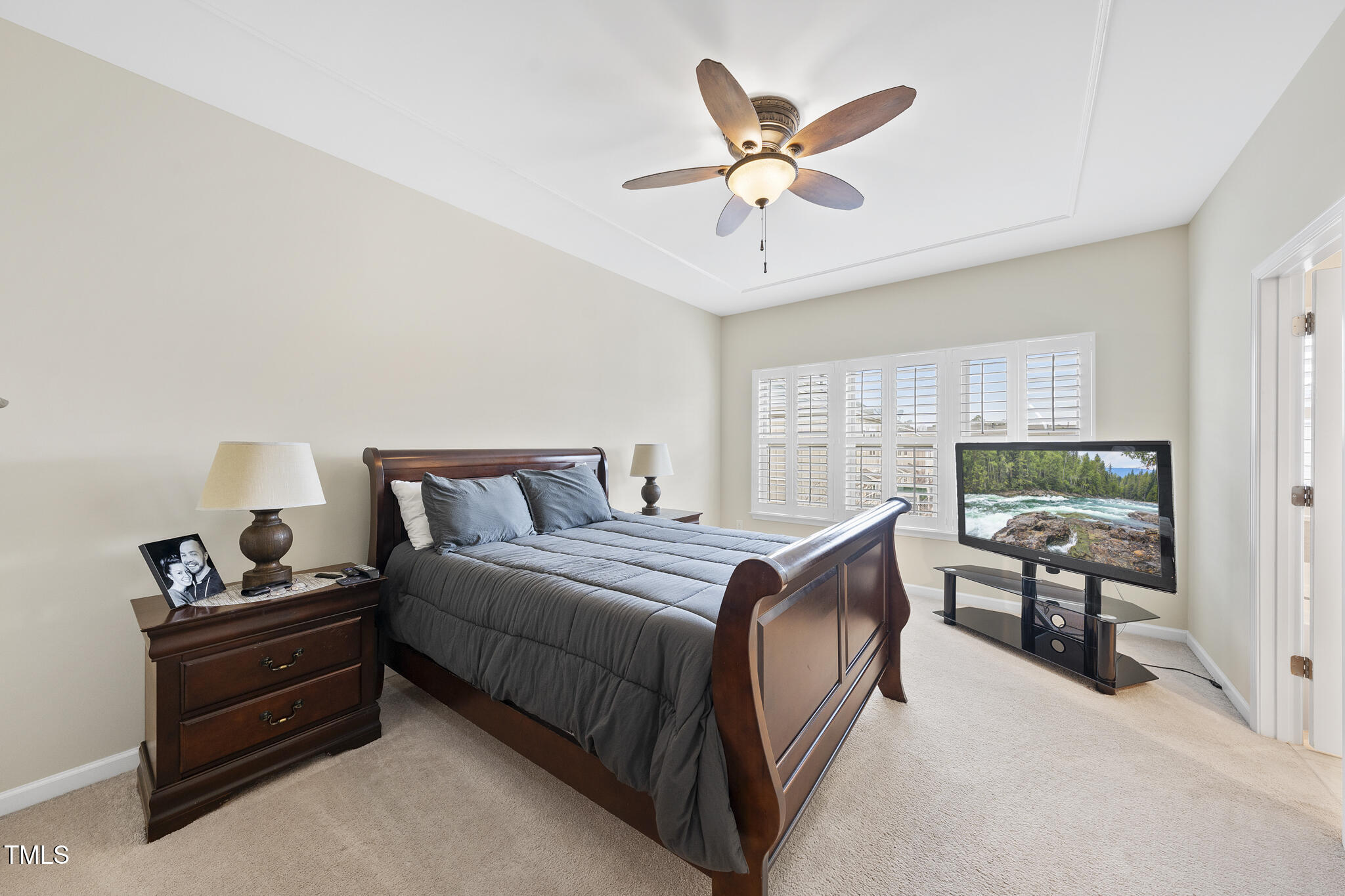 1319 Rodessa Run Raleigh, NC 27607 - Photo 17 of 34 a bedroom with a bed and a chandelier