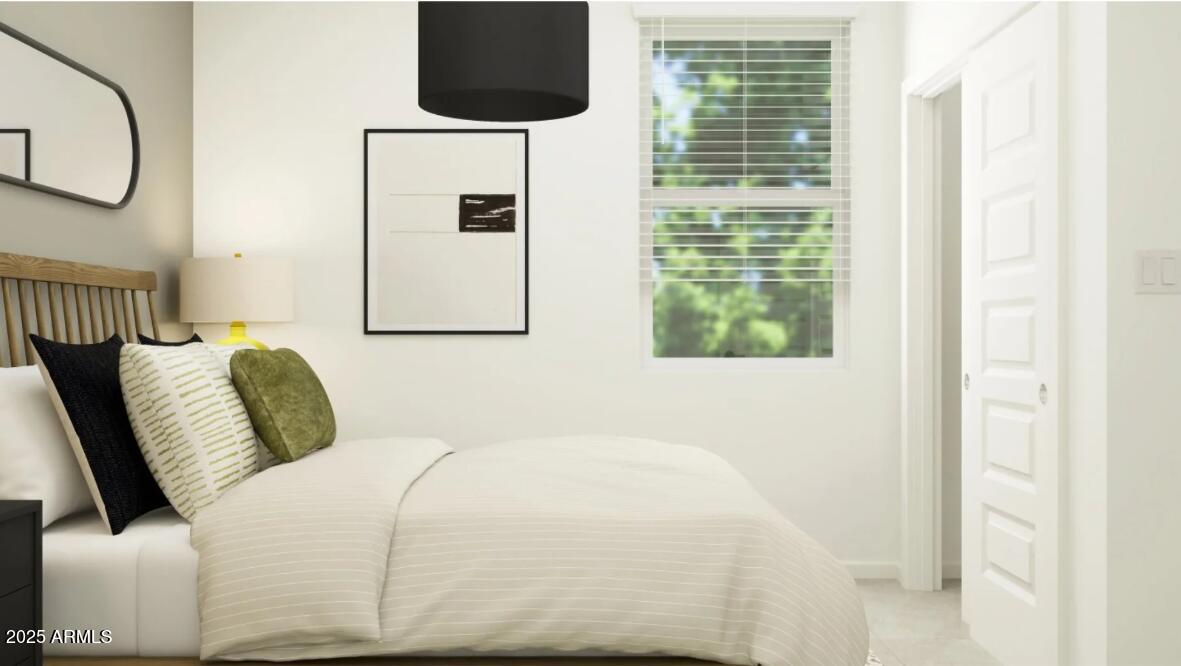 14955 West Hackamore Drive Surprise, AZ 85387 - Photo 11 of 19 a bedroom with a bed a flat screen tv and a window