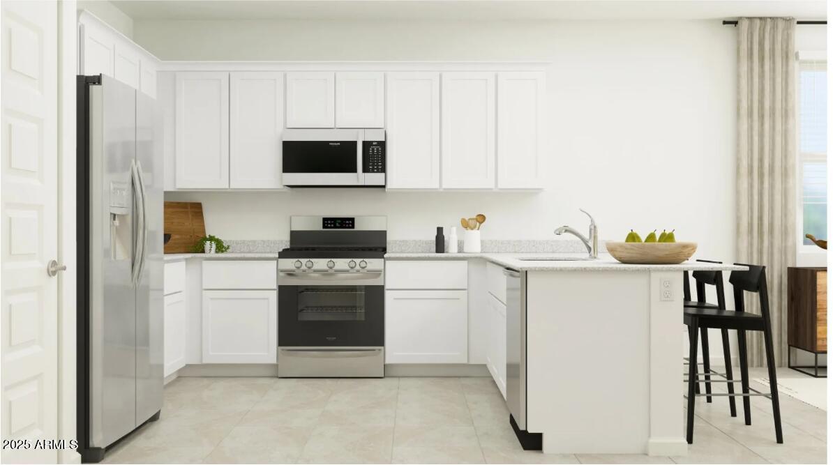 14955 West Hackamore Drive Surprise, AZ 85387 - Photo 3 of 19 a kitchen with stainless steel appliances granite countertop a refrigerator sink and white cabinets