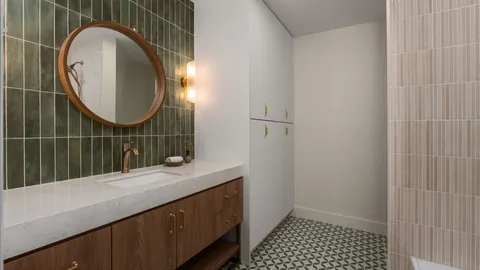 a bathroom with a sink a mirror and a shower