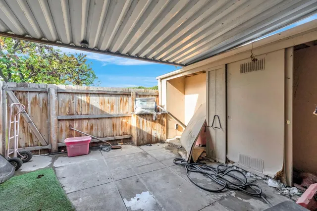 a view of a porch with furniture and a window