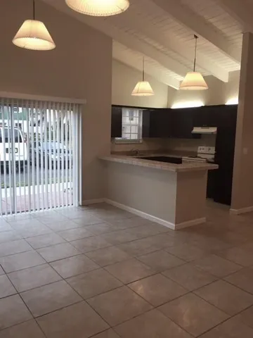 a kitchen with stainless steel appliances granite countertop a sink and a stove