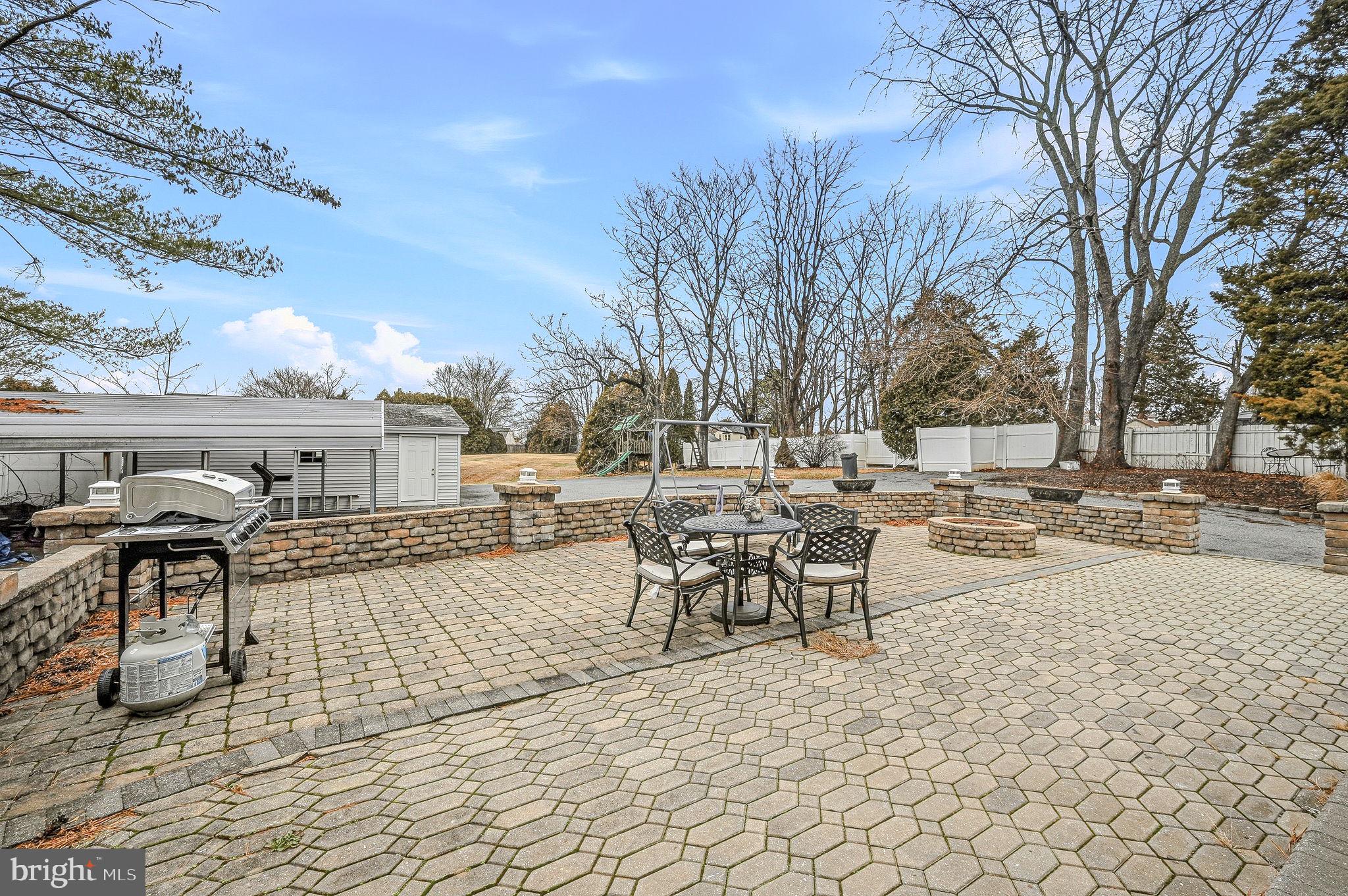 346 Bear Christiana Road Bear, DE 19701 - Photo 29 of 35 a view of a terrace with chairs and fire pit