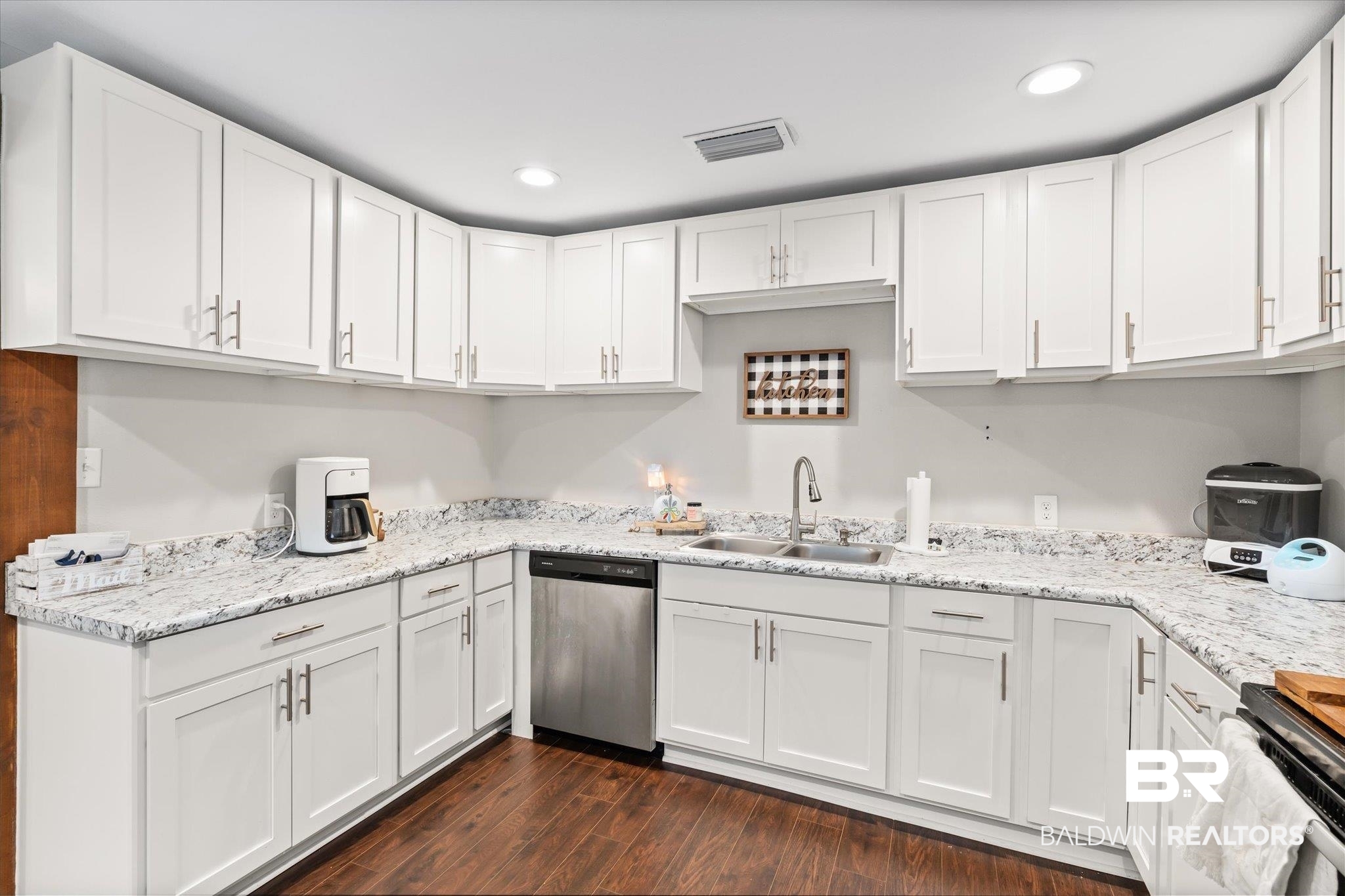 419 Pierce Street Saraland, AL 36571 - Photo 6 of 21 Kitchen featuring sink, white cabinetry, stainless steel dishwasher, dark hardwood / wood-style floors, and stove