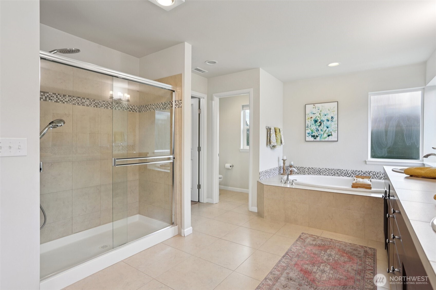 14025 163rd Place Southeast Renton, WA 98059 - Photo 15 of 33 a spacious bathroom with a tub shower and mirror