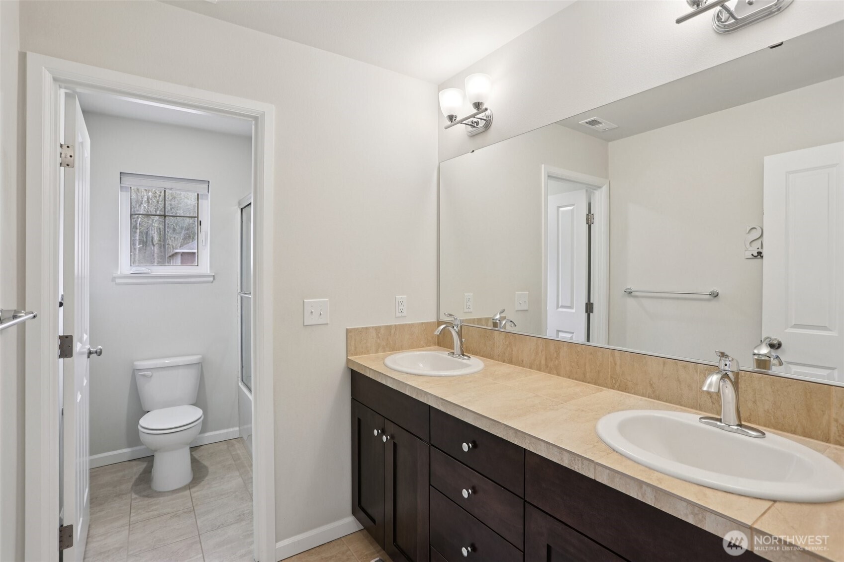 14025 163rd Place Southeast Renton, WA 98059 - Photo 17 of 33 a bathroom with a double vanity sink toilet and a mirror