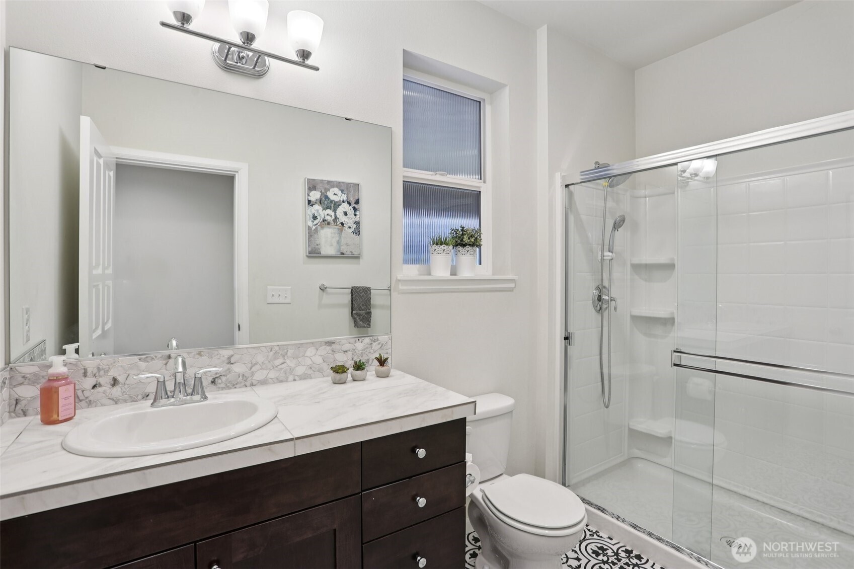 14025 163rd Place Southeast Renton, WA 98059 - Photo 25 of 33 a bathroom with a double vanity sink toilet mirror and shower