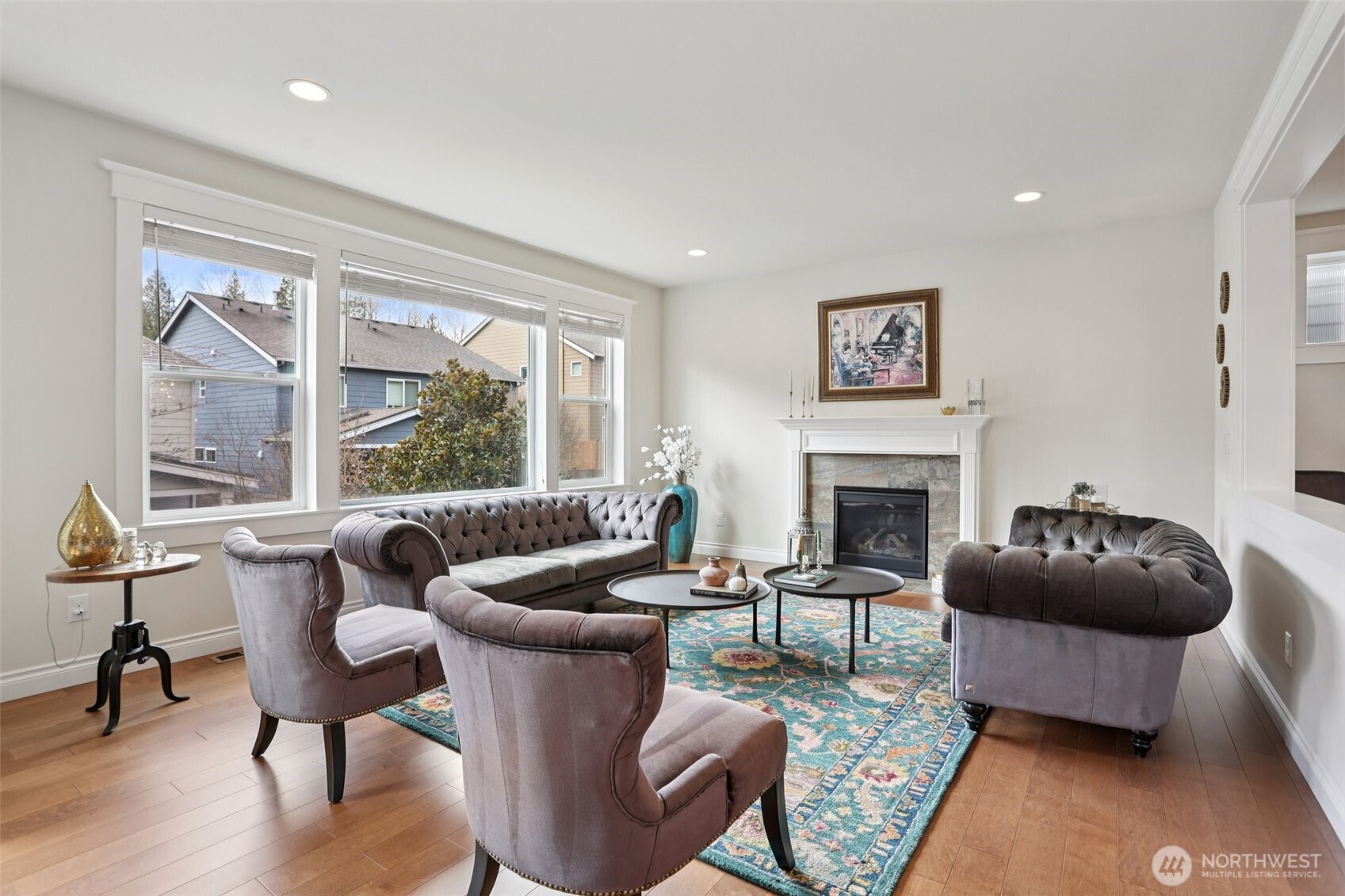 14025 163rd Place Southeast Renton, WA 98059 - Photo 3 of 33 a living room with furniture a large window and a fireplace