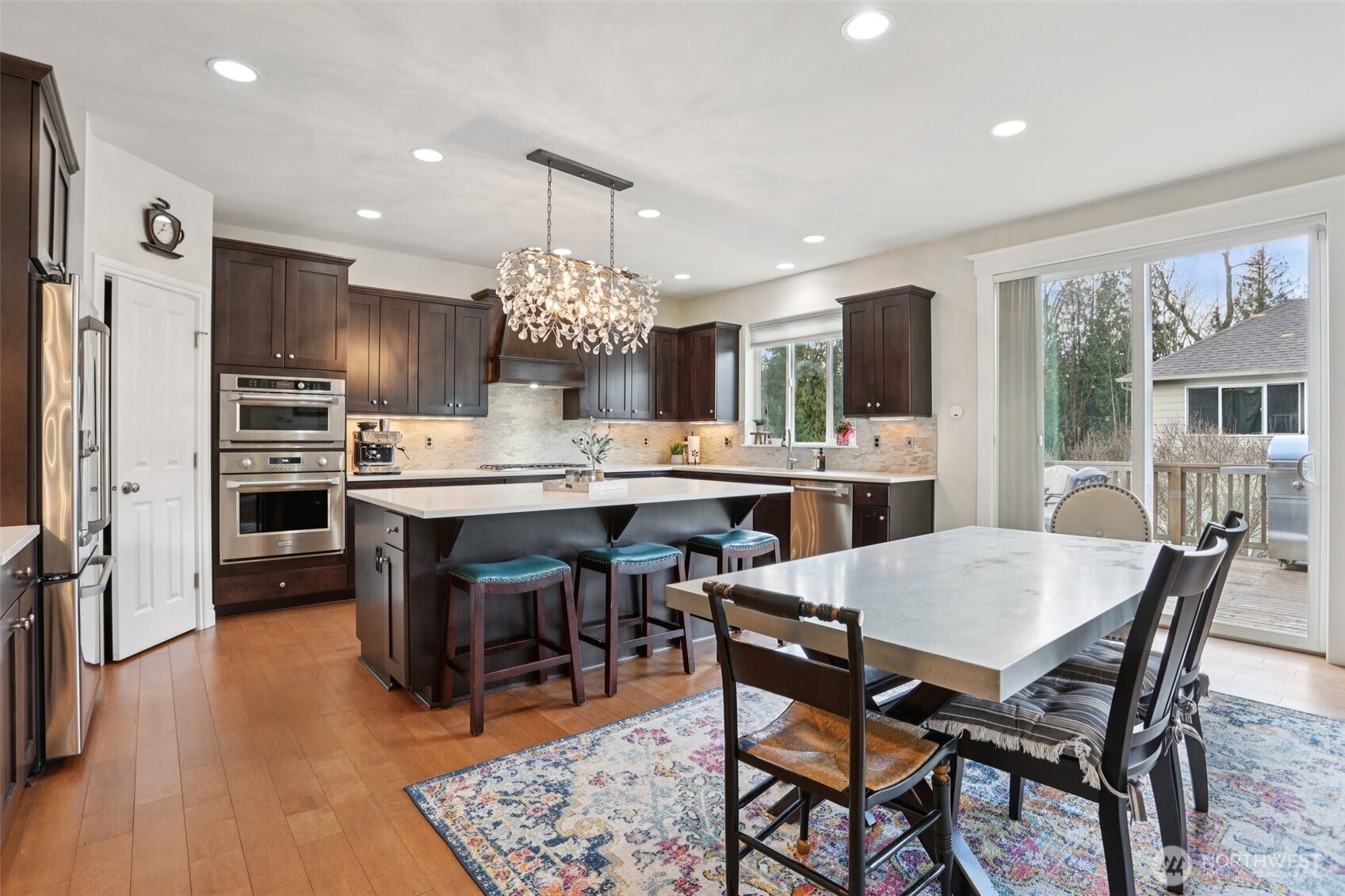 14025 163rd Place Southeast Renton, WA 98059 - Photo 4 of 33 a view of a dining room with furniture and wooden floor