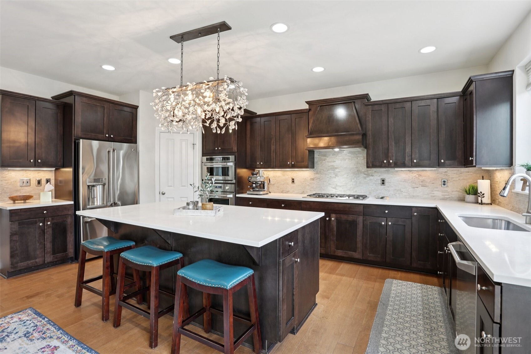 14025 163rd Place Southeast Renton, WA 98059 - Photo 5 of 33 a kitchen with kitchen island granite countertop a sink stove and refrigerator
