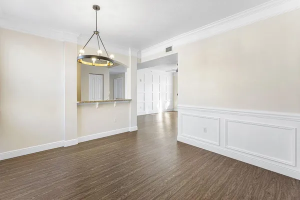 a view of empty room with wooden floor and window