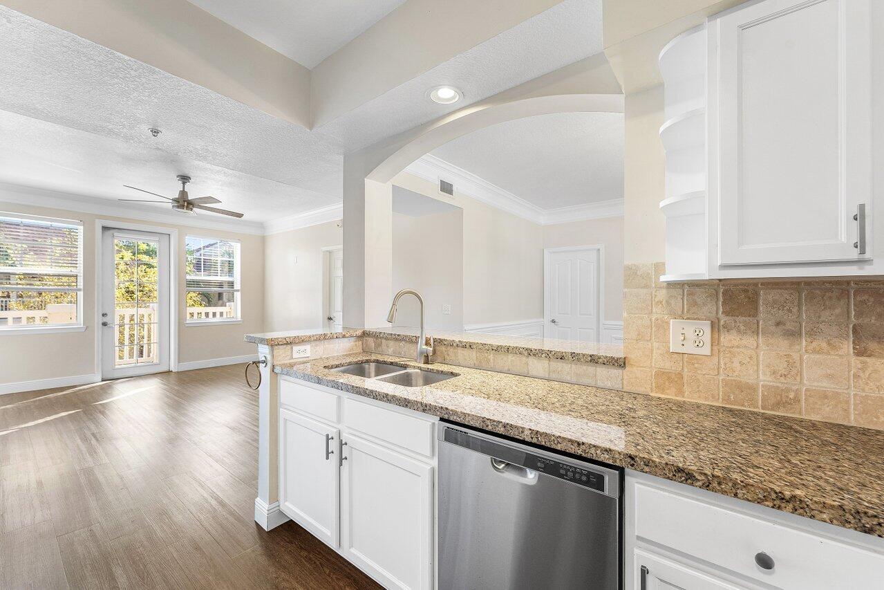 276 Murcia Drive, Unit 301 Jupiter, FL 33458 - Photo 16 of 52 a kitchen with stainless steel appliances granite countertop a sink stove and cabinets