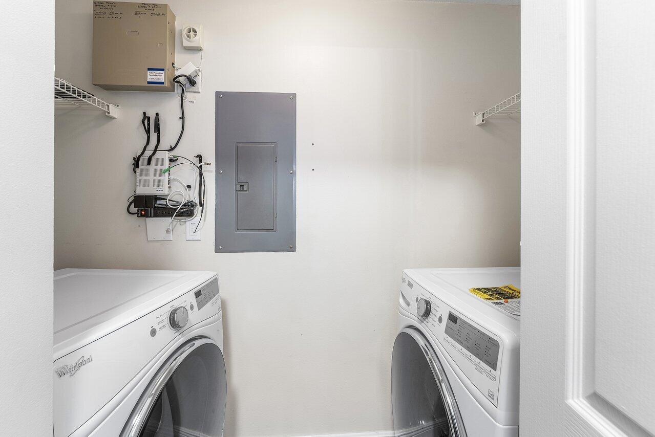 276 Murcia Drive, Unit 301 Jupiter, FL 33458 - Photo 18 of 52 a utility room with dryer and washer