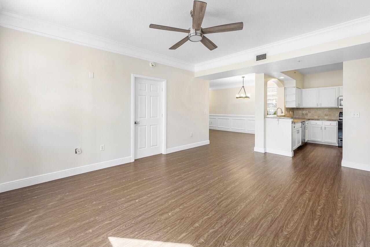 276 Murcia Drive, Unit 301 Jupiter, FL 33458 - Photo 21 of 52 an empty room with wooden floor and windows