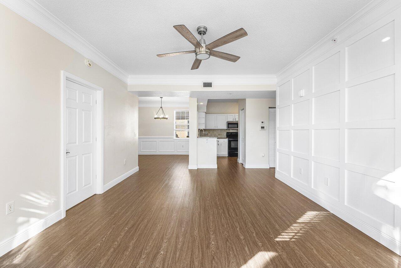 276 Murcia Drive, Unit 301 Jupiter, FL 33458 - Photo 22 of 52 a view of a livingroom with wooden floor and a ceiling fan