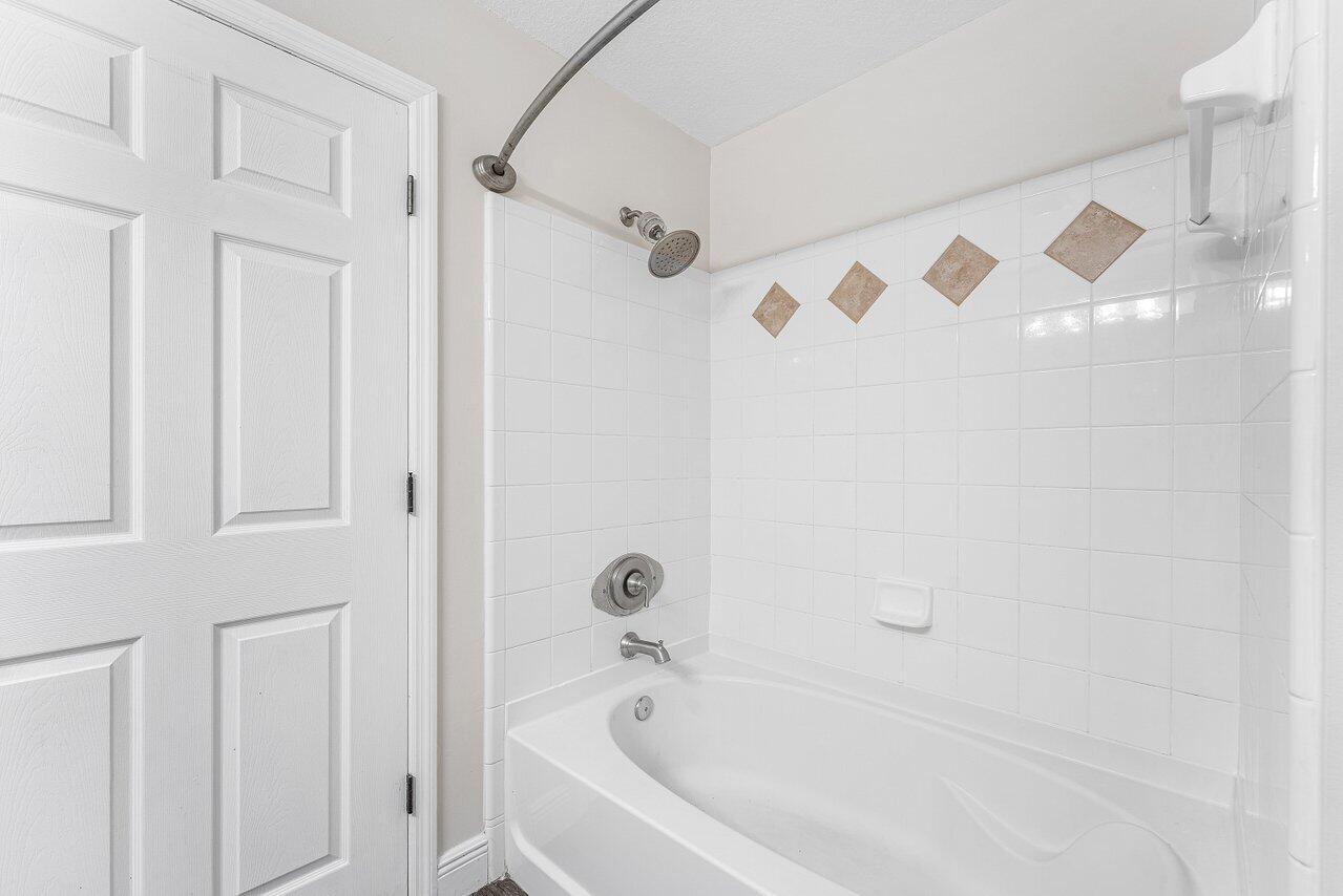 276 Murcia Drive, Unit 301 Jupiter, FL 33458 - Photo 26 of 52 a white bath tub with shower
