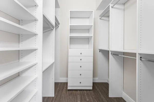 a view of walk in closet with empty racks
