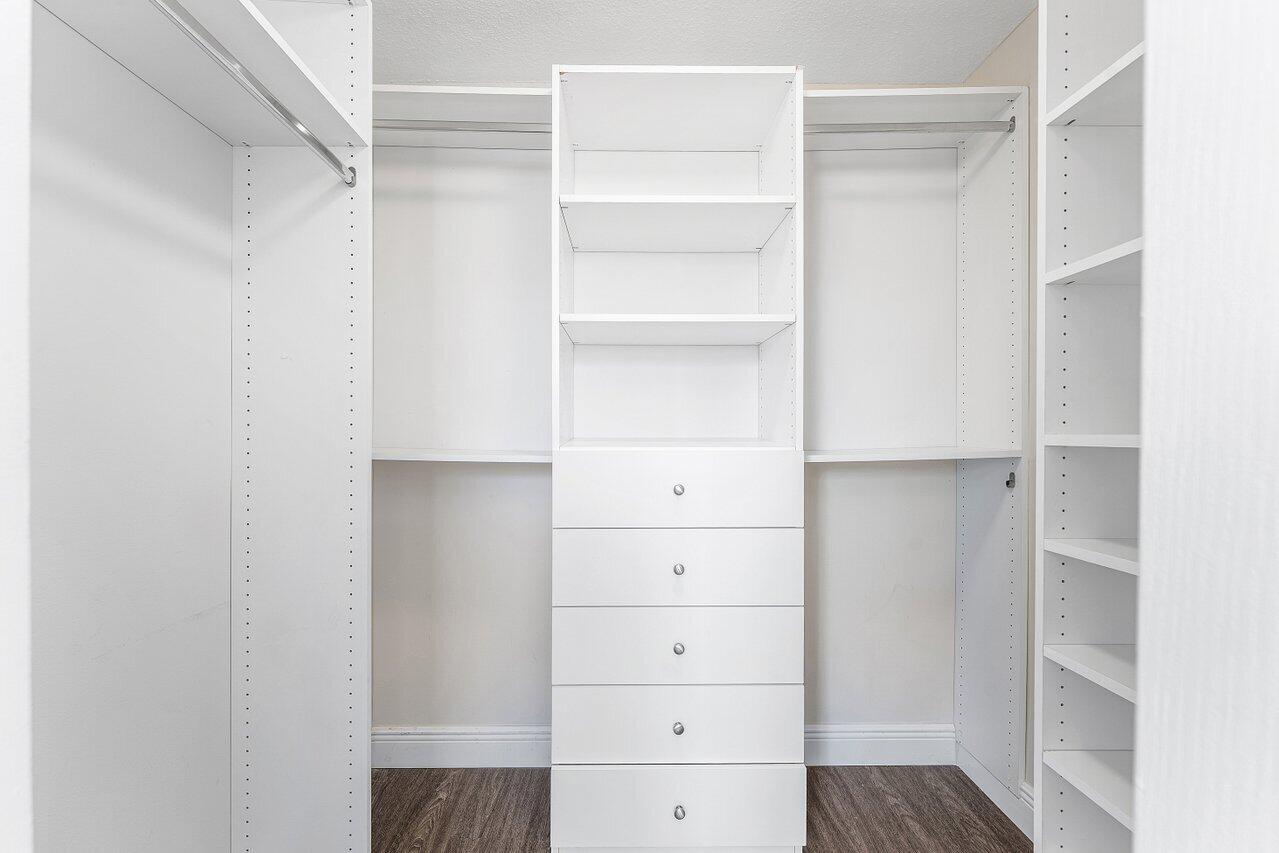 276 Murcia Drive, Unit 301 Jupiter, FL 33458 - Photo 28 of 52 a view of walk in closet with empty racks