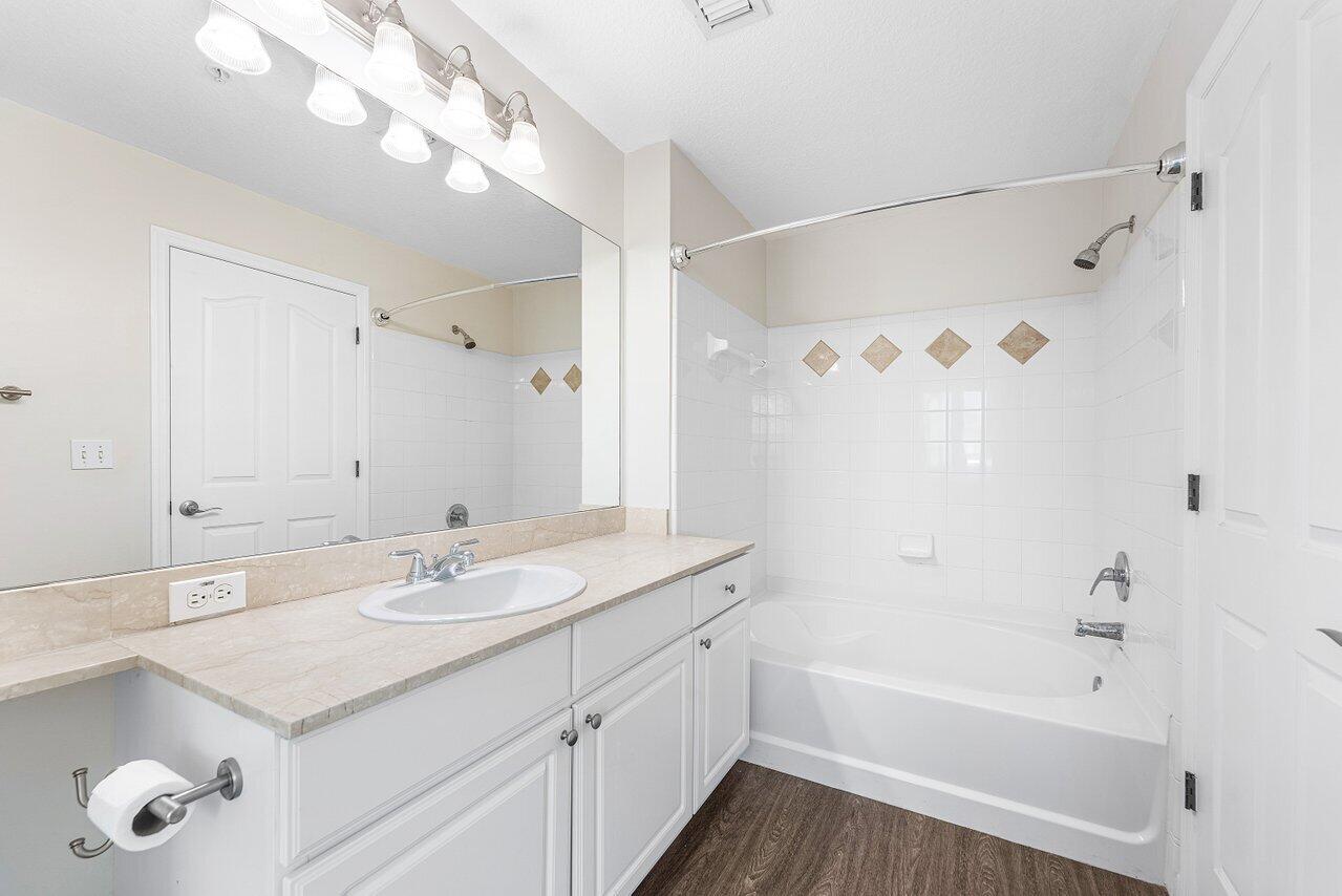 276 Murcia Drive, Unit 301 Jupiter, FL 33458 - Photo 29 of 52 a bathroom with a sink a tub and a mirror