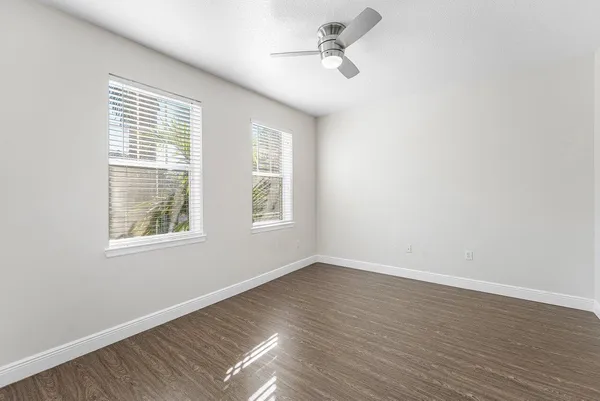 a view of an empty room with wooden floor