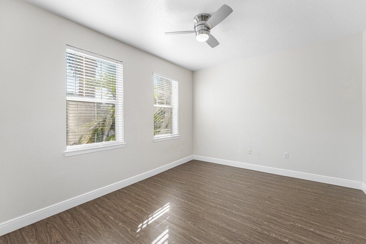 276 Murcia Drive, Unit 301 Jupiter, FL 33458 - Photo 30 of 52 a view of empty room with wooden floor and fan