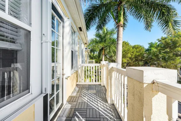 a view of a house with a small yard and wooden fence