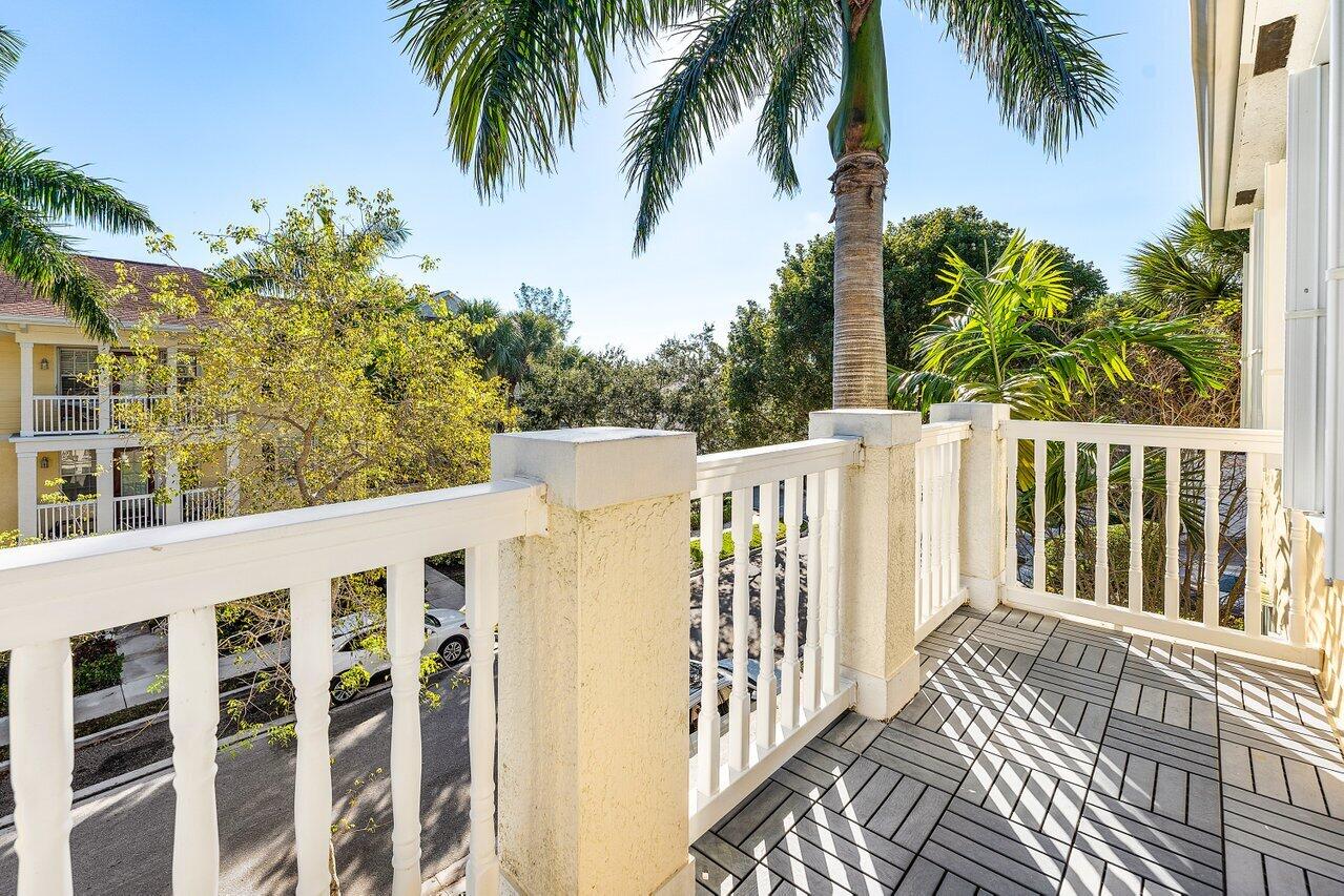 276 Murcia Drive, Unit 301 Jupiter, FL 33458 - Photo 33 of 52 a view of a house with a small yard and wooden fence