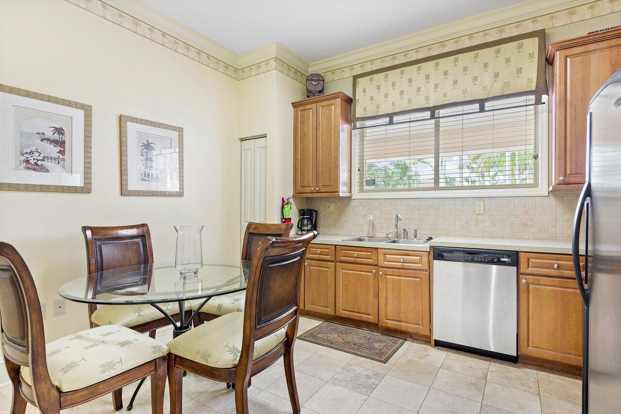 276 Murcia Drive, Unit 301 Jupiter, FL 33458 - Photo 41 of 52 a kitchen with stainless steel appliances granite countertop a stove a sink dishwasher and cabinets