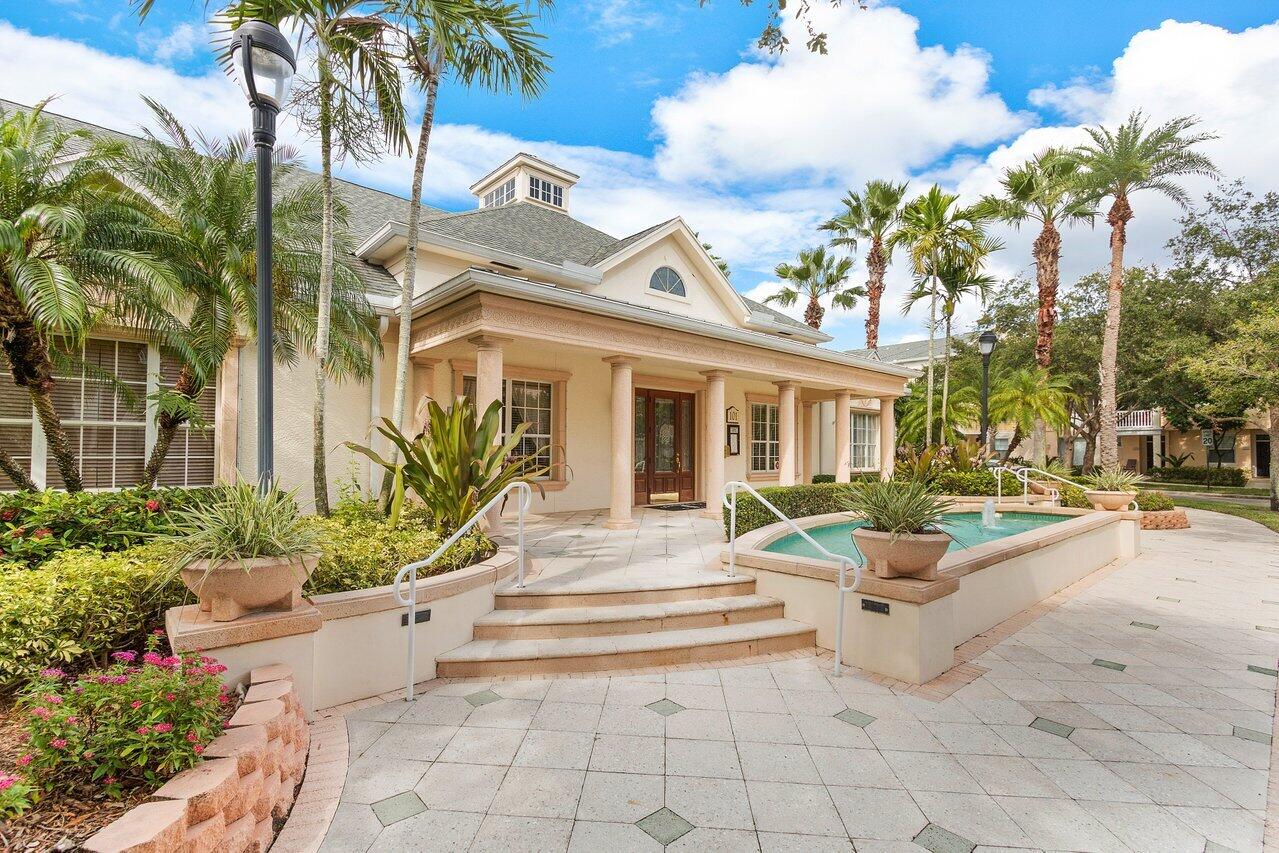 276 Murcia Drive, Unit 301 Jupiter, FL 33458 - Photo 42 of 52 a view of a building with potted plants and a lawn chairs