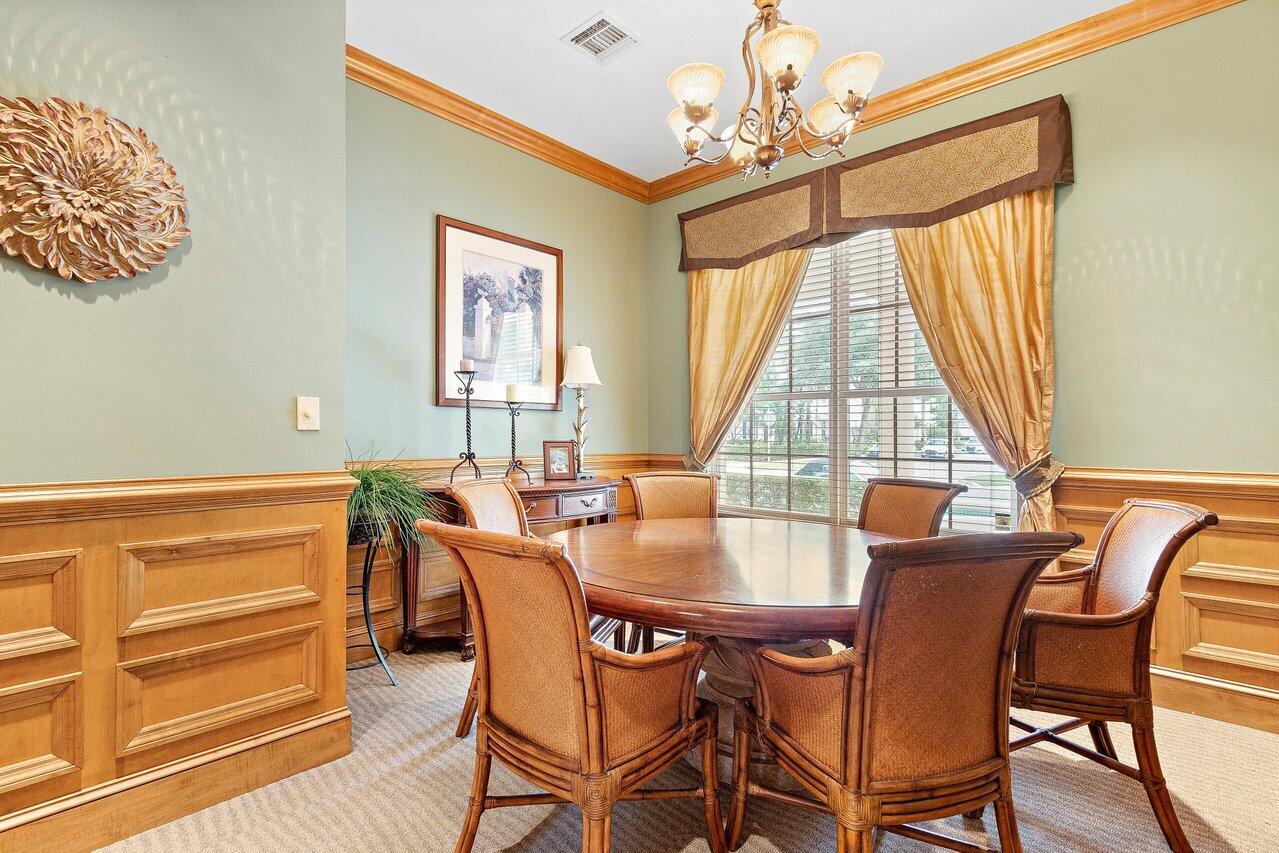 276 Murcia Drive, Unit 301 Jupiter, FL 33458 - Photo 46 of 52 a dining room with furniture a chandelier and wooden floor
