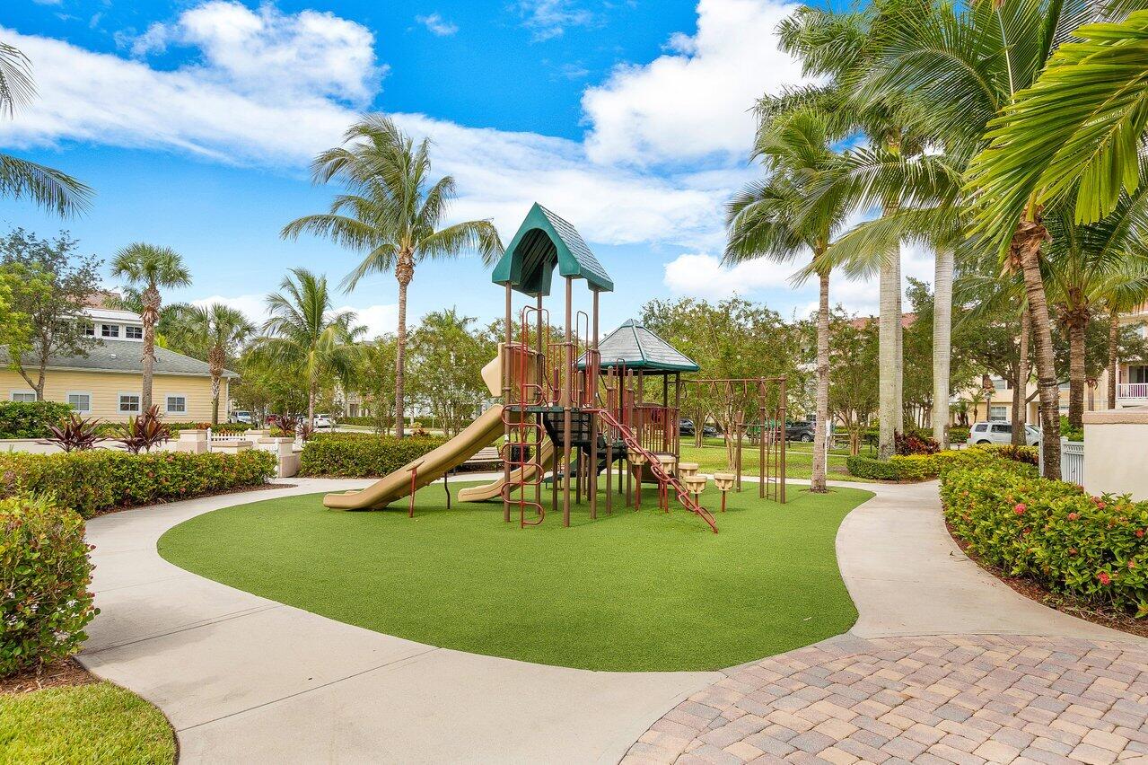 276 Murcia Drive, Unit 301 Jupiter, FL 33458 - Photo 48 of 52 a view of a swimming pool with a garden and plants