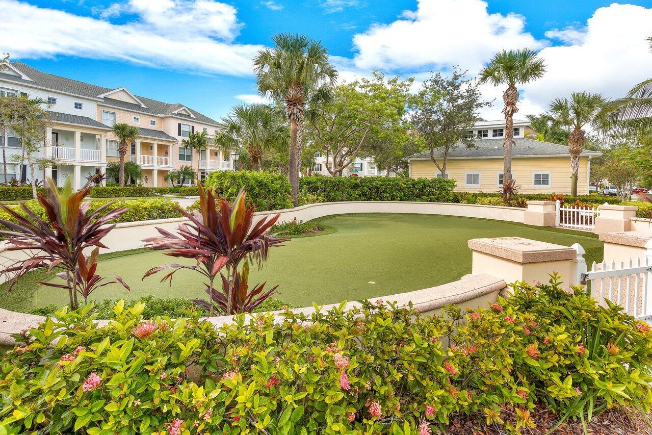 276 Murcia Drive, Unit 301 Jupiter, FL 33458 - Photo 50 of 52 a view of a swimming pool with a lounge chair