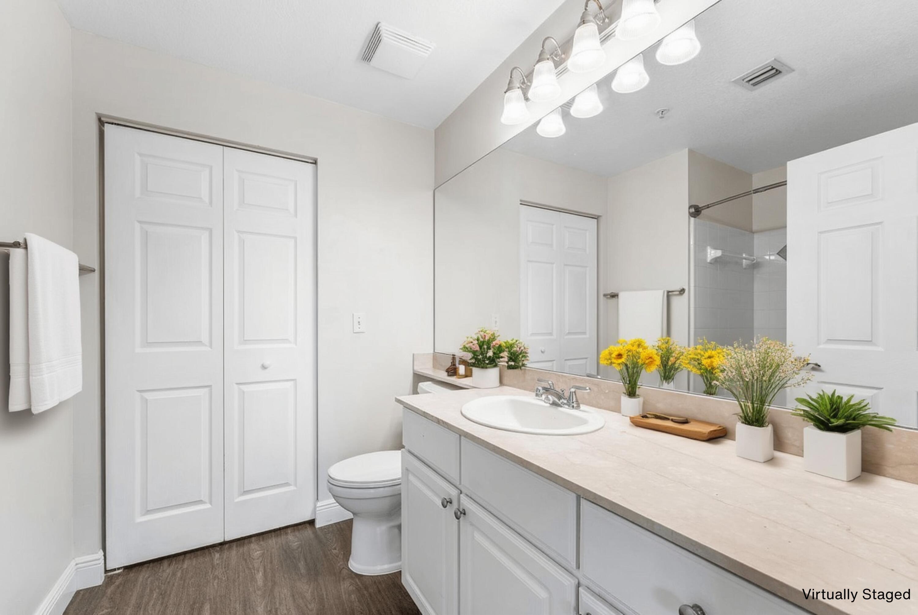 276 Murcia Drive, Unit 301 Jupiter, FL 33458 - Photo 5 of 52 a bathroom with a granite countertop sink a toilet and a mirror