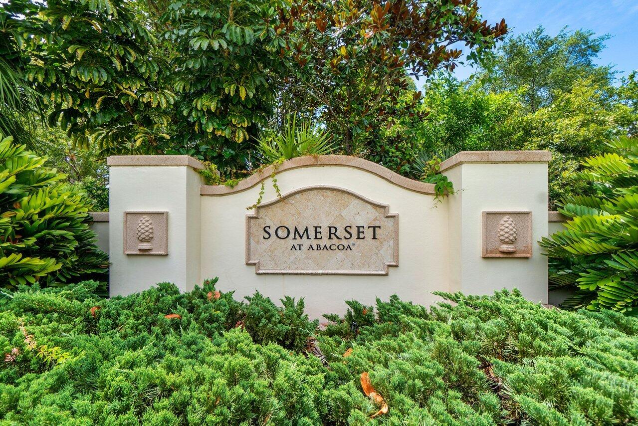 276 Murcia Drive, Unit 301 Jupiter, FL 33458 - Photo 52 of 52 a sign that is sitting in front of a wall with plants