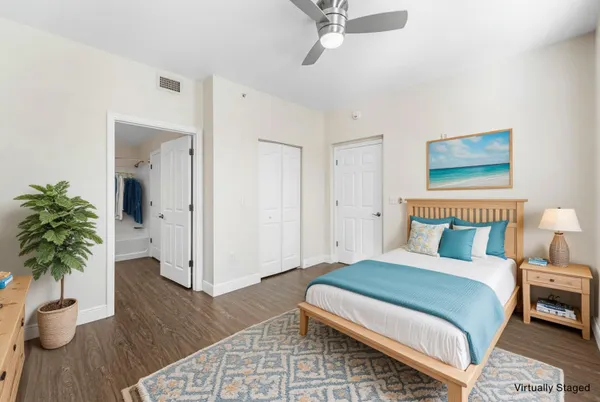 a bedroom with a bed and a potted plant