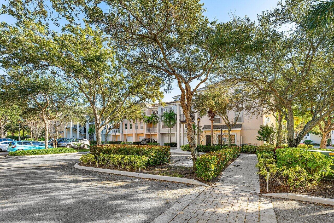 276 Murcia Drive, Unit 301 Jupiter, FL 33458 - Photo 9 of 52 a view of a street with houses on both side