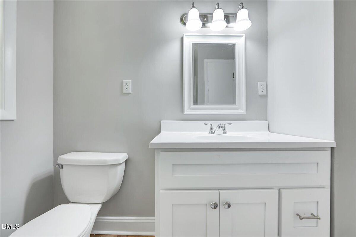 3408 Atlantic Avenue Raleigh, NC 27604 - Photo 16 of 48 a bathroom with a sink toilet and a mirror