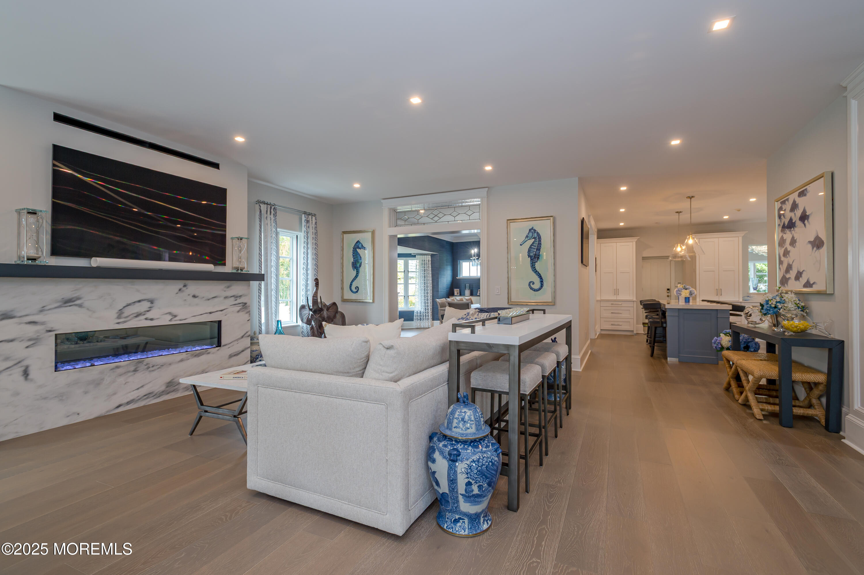 112 Passaic Avenue Spring Lake, NJ 07762 - Photo 11 of 69 a living room with furniture a fireplace a flat screen tv and kitchen view