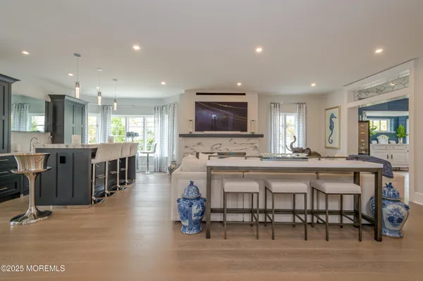 a kitchen with a dining table chairs and refrigerator