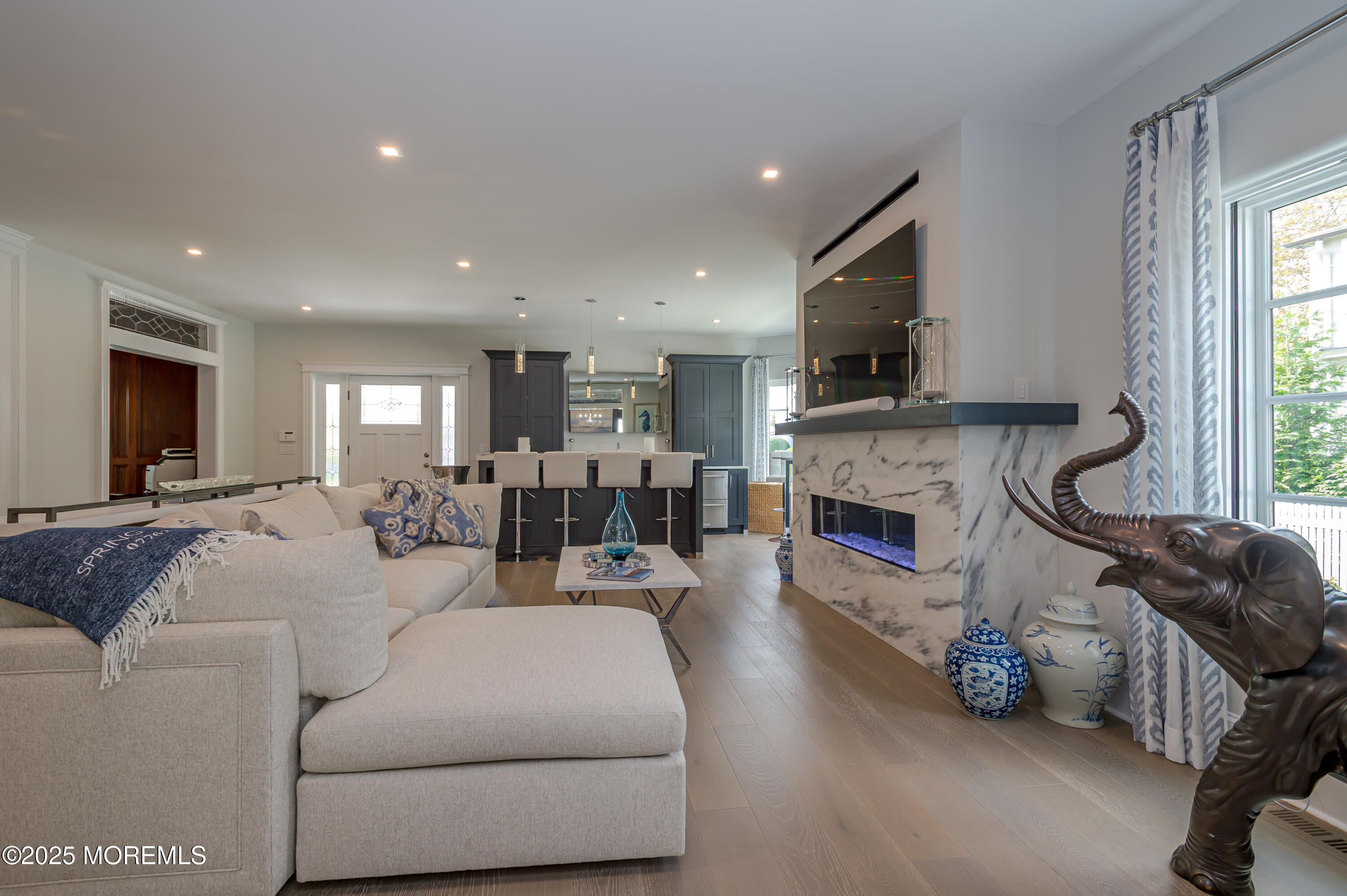 112 Passaic Avenue Spring Lake, NJ 07762 - Photo 13 of 69 a living room with furniture a fireplace and a flat screen tv