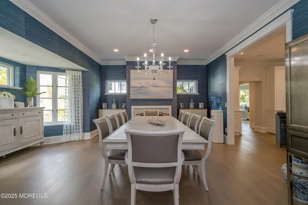 a large kitchen with kitchen island a sink a stove a dining table and chairs