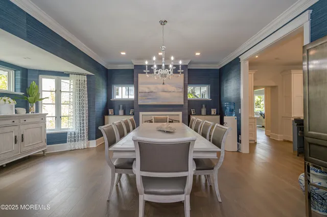 a large kitchen with kitchen island a sink a stove a dining table and chairs