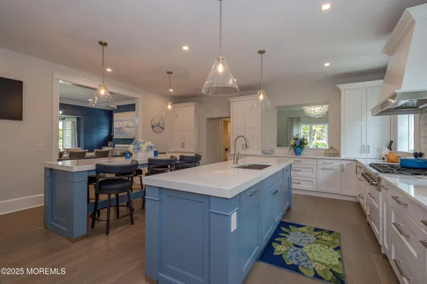 a view of living room kitchen with furniture and wooden floor