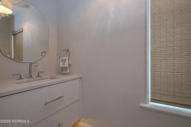 a spacious bathroom with a shower sink and mirror