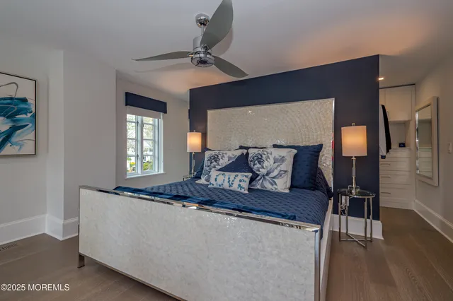 a bedroom with a large bed and a chandelier