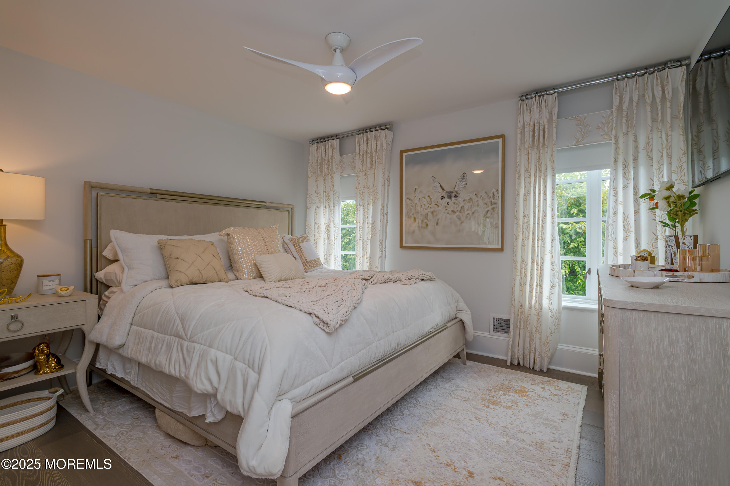 112 Passaic Avenue Spring Lake, NJ 07762 - Photo 33 of 69 a bedroom with a large bed and a chandelier