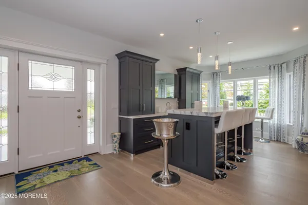a view of a room with wooden floor and windows
